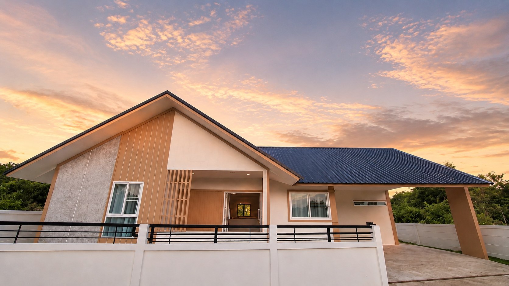 Warm gabled residence below a cinematic sunset sky